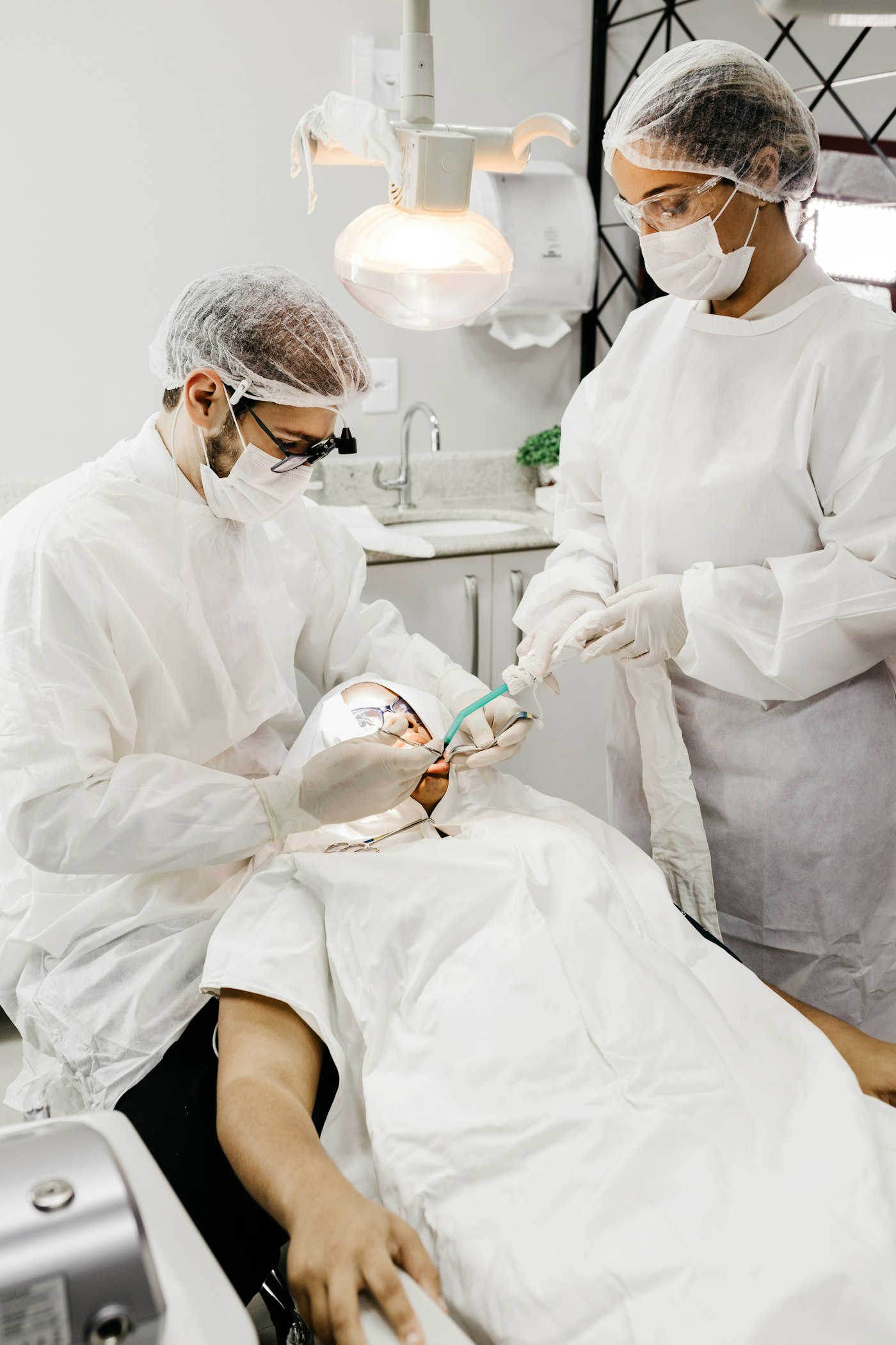 Dentist preparing patient for dental implant treatment
